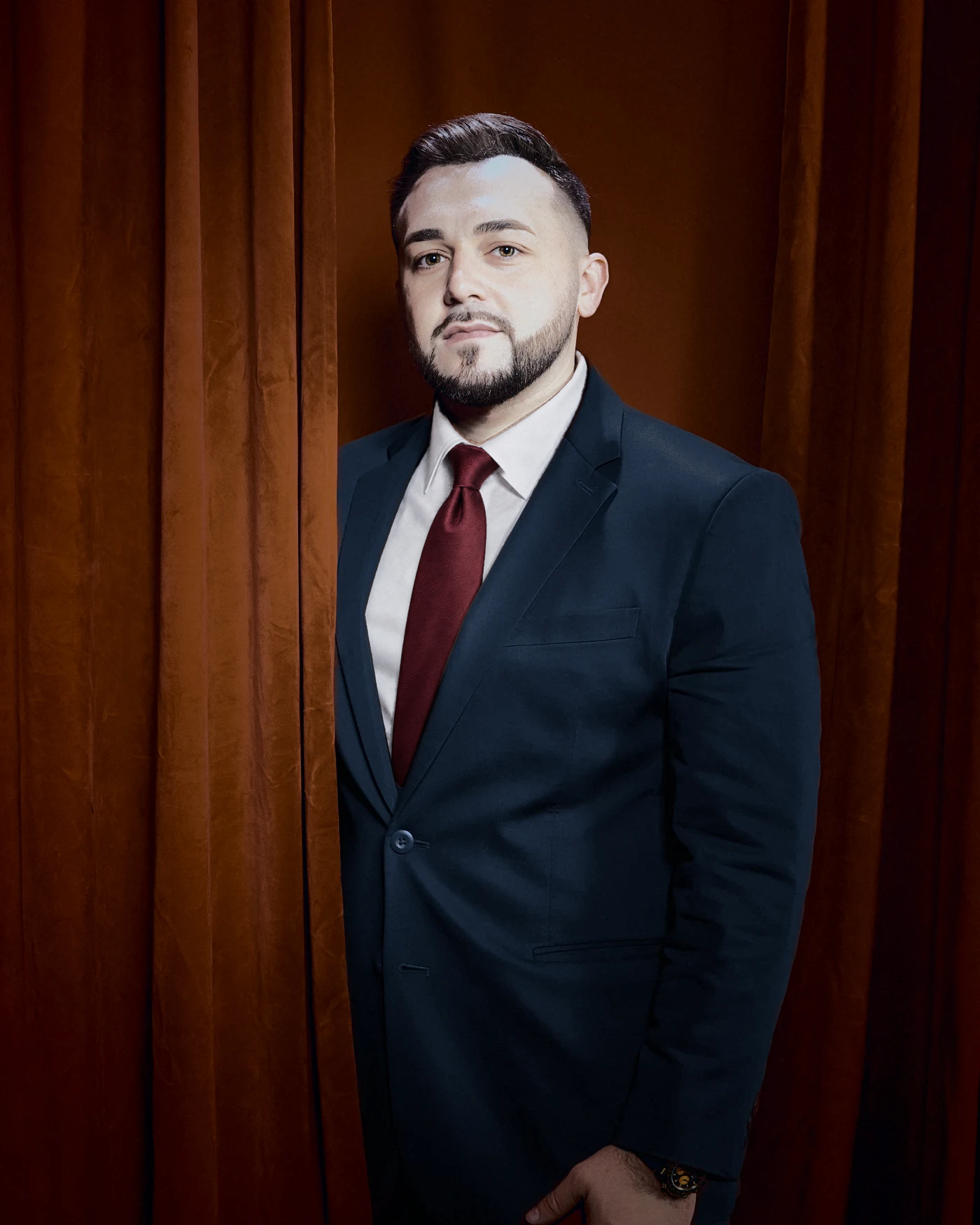Chris Michael in front of a curtain