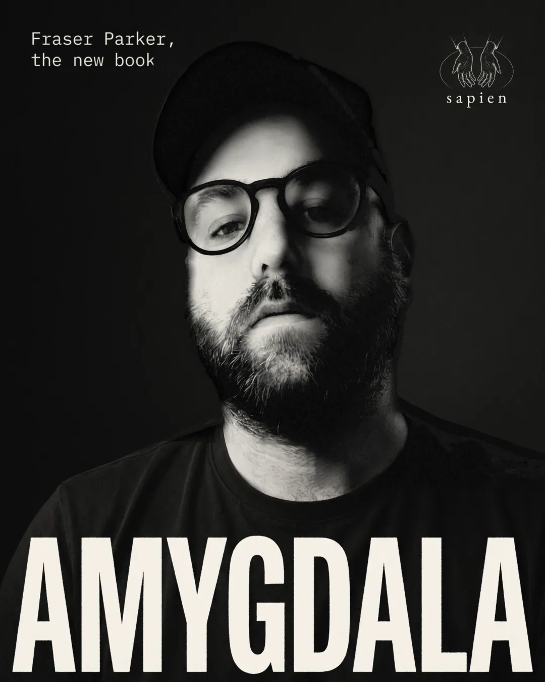 Fraser Parker in black and white, in a cap and glasses, with the word Amygdala across his chest